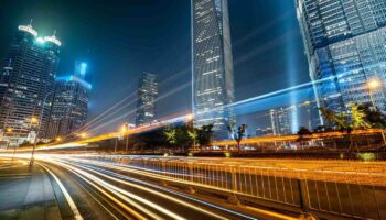 modern city of shanghai in a beautiful night ,futuristic urban building with light trails