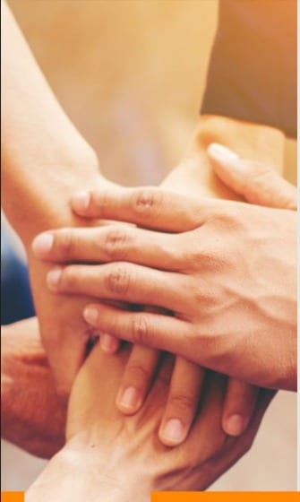 Team hands stacked in unity